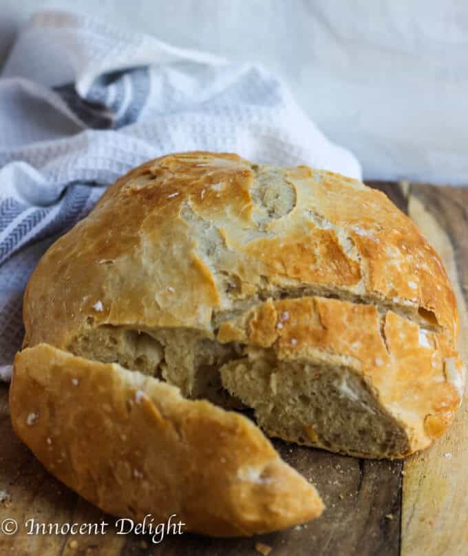 This Homemade Dutch Oven Crusty Bread tastes like the fresh bread straight from the best bakery. But it comes from your oven and it only takes 10 minutes of prep time. There is no kneading involved! Partially sliced Homemade Dutch Oven Crusty Bread