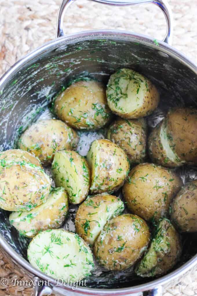 New Dill Potatoes with Scallion Cream Sauce - Polish summer staple side dish. This type of potatoes are the creamiest out there and they are only available for the short period of time. Hurry up, get some on your local farmer's market and follow this recipe to try the best potatoes you have ever tasted.