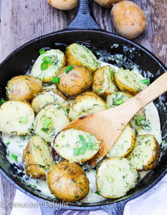 New Dill Potatoes with Scallion Cream Sauce - Polish summer staple side dish. This type of potatoes are the creamiest out there and they are only available for the short period of time. Hurry up, get some on your local farmer's market and follow this recipe to try the best potatoes you have ever tasted.