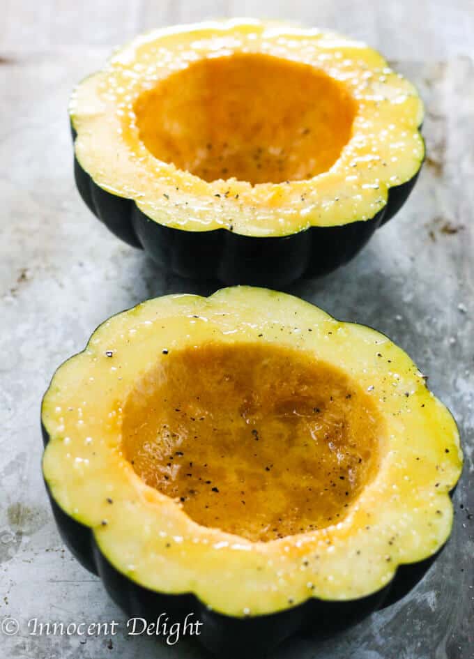 This Turkey Stuffed Acorn Squash with Apples, Cranberries & dried Thyme are irresistible with all the fall flavors in one dish. Roasted cut up acorn squash on a baking sheet