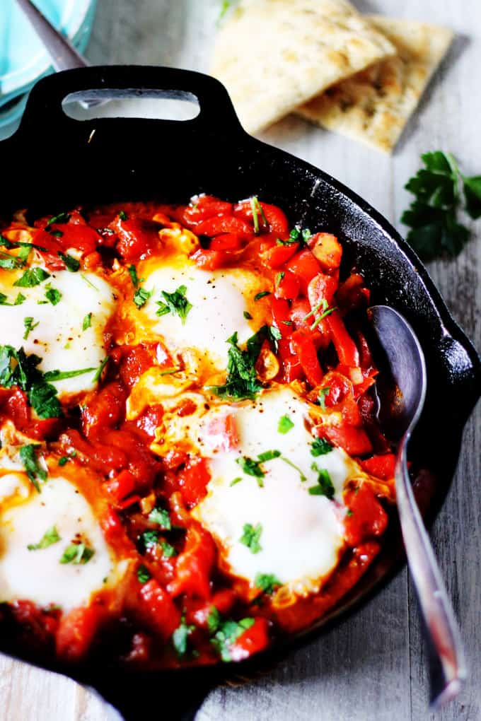 Mediterranean Breakfast Shakshuka in a skillet with spoon