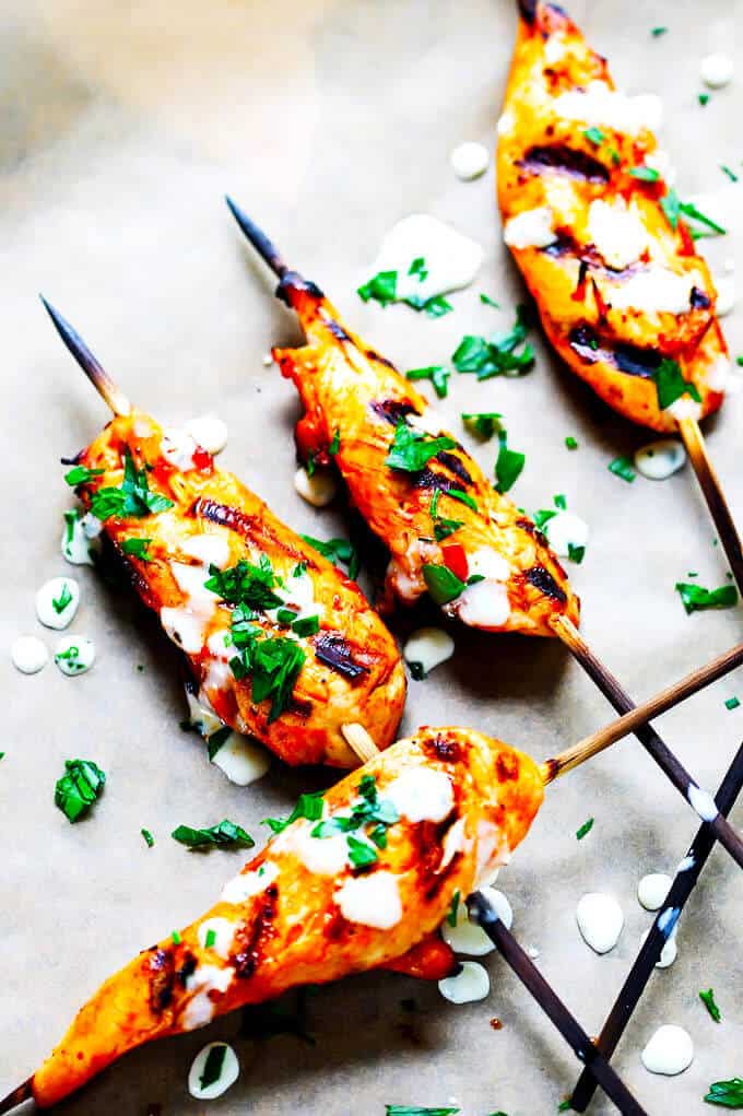 Honey Harrisa Chicken Skewers with Garlic Mint Sauce - amazing combination of Mediterranean flavors in these super tasty skewers with a dollops of refreshing garlic mint sauce. My guests couldn't get enough.
