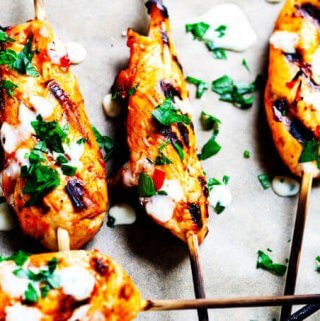 Honey Harrisa Chicken Skewers with Garlic Mint Sauce - amazing combination of Mediterranean flavors in these super tasty skewers with a dollops of refreshing garlic mint sauce. My guests couldn't get enough.