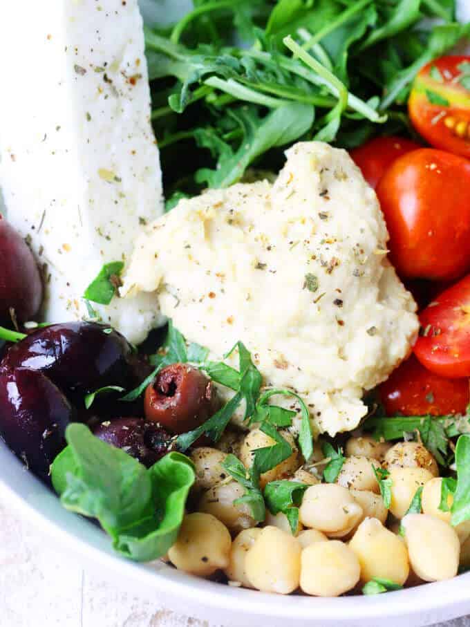 This is a super easy and super healthy dish inspired by the Mediterranean diet that can be easily served for lunch or light dinner. The best part is that this Mediterranean Hummus Bowl can be ready in 10 minutes. Mediterranean Hummus Bowl with Kalamata Olives Feta and Tomateos