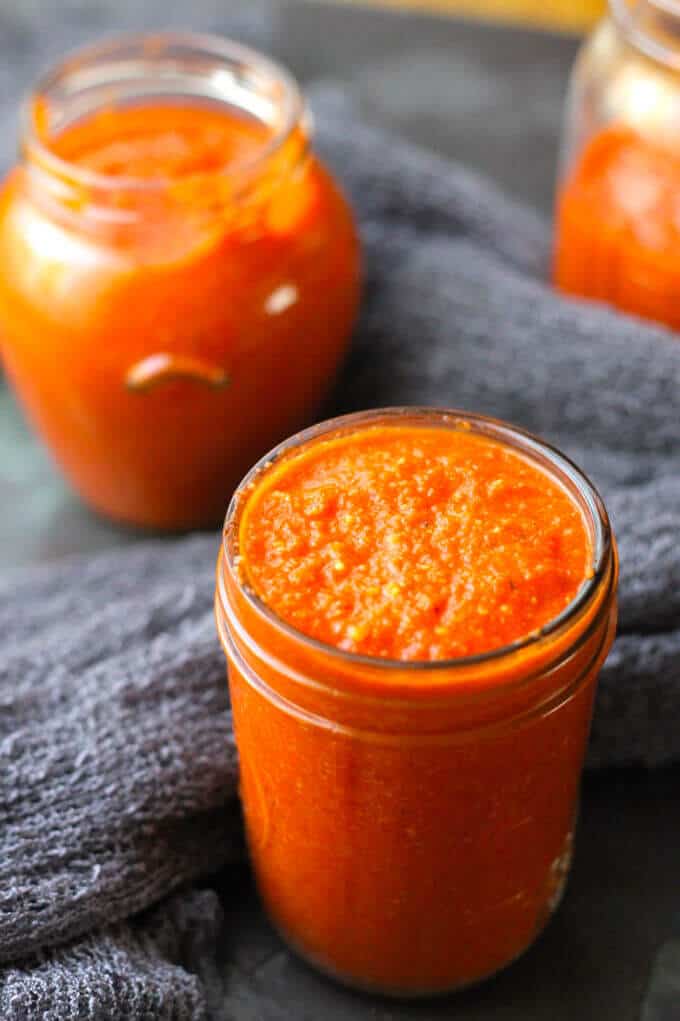 Romesco Sauce - famous Spanish sauce with roasted peppers, tomatoes, onions, garlic, almonds, bread, olive oil, vinegar, and Spanish Smoked Paprika. Easy and delicious. Spanish Sauce - Romesco in mason jars.