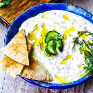 Traditional Greek Tzatziki Recipe combines real thick greek yogurt, seedless cucumber, garlic, dill and splash of vinegar and olive oil. It's a perfect sauce that can be paired with any meals like: grilled meats, vegetables, sandwiches, pitas or salads.