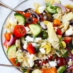 Farfalle Pasta Salad Mediterranean Style is a great pasta salad with super fresh ingredients like cucumbers, tomatoes, onions and peppers. Extra flavors come form Kalamata Olives, marinated artichokes and feta cheese. Dressed with red wine based vinaigrette instead of mayo makes for super light and refreshing side dish.