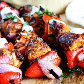 Mediterranean Chicken Kebabs with Garlic Yogurt sauce are packed with flavor. Marinated in Mediterranean spices, garlic and lemon, grilled to perfection and topped with cooling garlic yogurt sauce these chicken skewers are real winners.