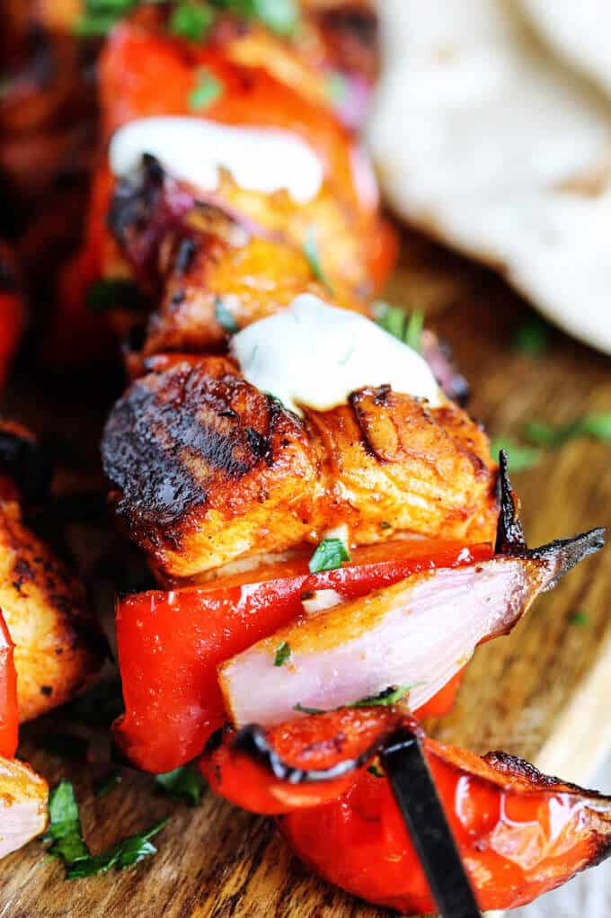 Mediterranean Chicken Kebabs with Garlic Yogurt sauce are packed with flavor. Marinated in Mediterranean spices, garlic and lemon, grilled to perfection and topped with cooling garlic yogurt sauce these chicken skewers are real winners.