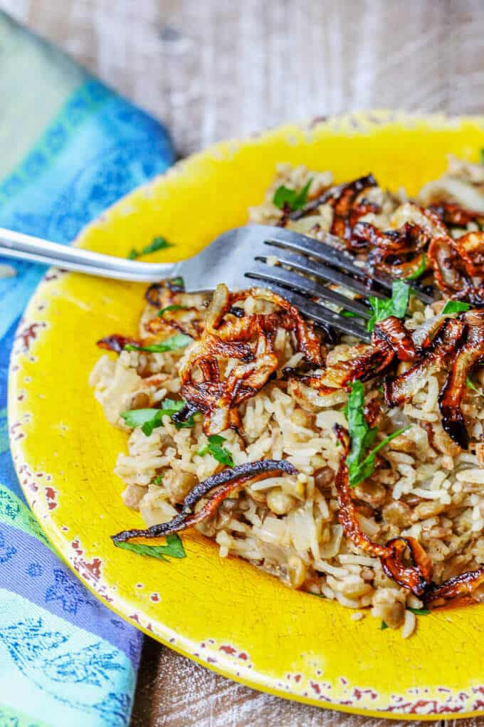 Lebanese Mujadara Recipe combines lentils with rice for a perfect protein meal. Seasoned with Middle Eastern flavors and topped with crispy fried onions makes for a truly irresistible dish.