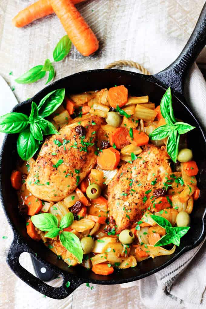 Fennel Chicken with carrots, raisins and olives in cast iron pan
