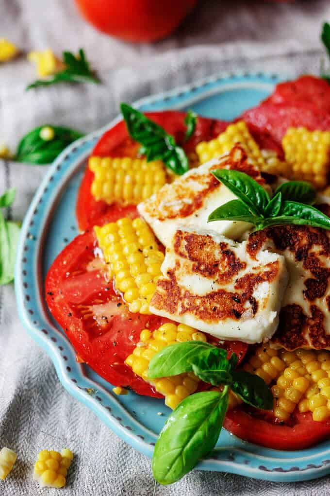Fried Halumi Cheese with Corn and Tomatoes is an amazing summer appetizer. This humble cheese from Cyprus will make an unforgettable experience.