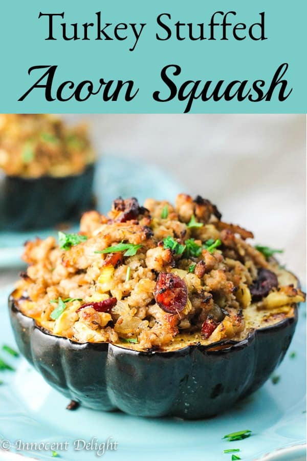 Turkey Stuffed Acorn Squash with Apples and Cranberries is a perfect fall dinner that uses seasonal ingredients and is very easy to make. #turkey #acornsquash #squash #fall #apples #easydinner #cranberries Turkey Stuffed Acorn Squash with Apples and Cranberries on a blue plate