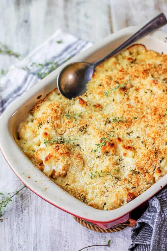 Cauliflower Pasta Bake with Brie and Fontina is like a combination of a fancy mac & cheese with veggies! Two dishes at ones. Cauliflower Pasta Bake with Brie and Fontina in a casserole with spoon