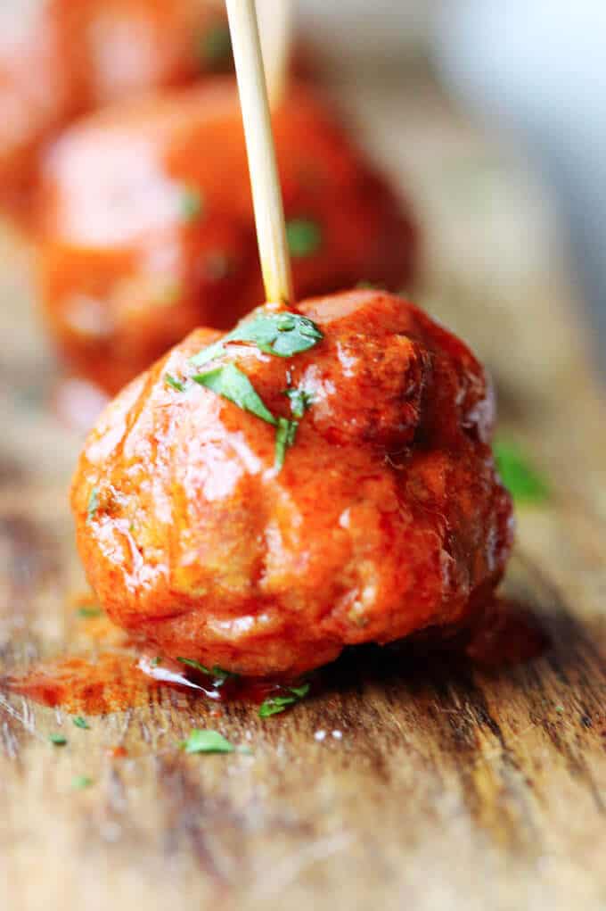 Buffalo Turkey Meatballs are a perfect appetizer for the Big Game. They're also a lighter alternative to a traditional chicken buffalo wings, not only because they have less fat, but also because they're baked, not fried. Not to mention they're also super easy to make. Buffalo Turkey Meatballs close up