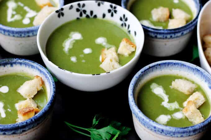 This Creamy Spinach Soup with Parmesan Croutons is very easy, healthy and by far the best spinach soup I've eaten. Not to mention, with a few simple substitutions it can even be transformed into a vegan soup. Creamy spinach soup with croutons on bowls