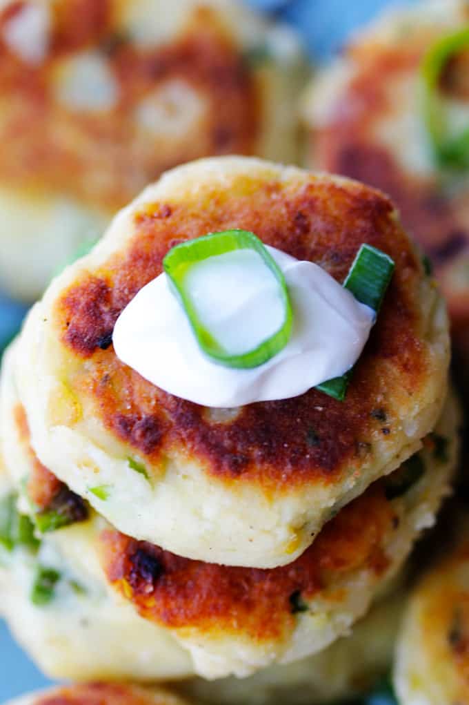 This recipe for Potato Cutlets with Asparagus is a keeper. In fact, the ease of preparation, coupled with deliciousness of the dish, might catapult this one into heavy rotation. Preparation just requires a few steps that and, again, the taste is amazing. Potatoes with asparagus - fried to perfection - and served with a dollop of sour cream and scallions. And while there are no breadcrumbs involved, they still achieve crispy and golden brown crust. Potato cutlets from the overhead with dollop of sour cream and scallion