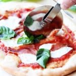 Cutting up through the pizza Margherita