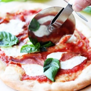 Cutting up through the pizza Margherita