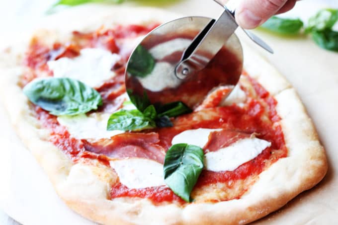 Cutting up through the pizza Margherita