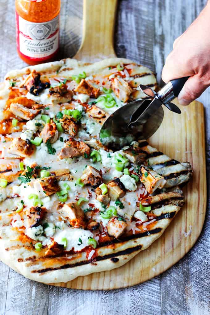 Cutting the buffalo chicken grilled pizza