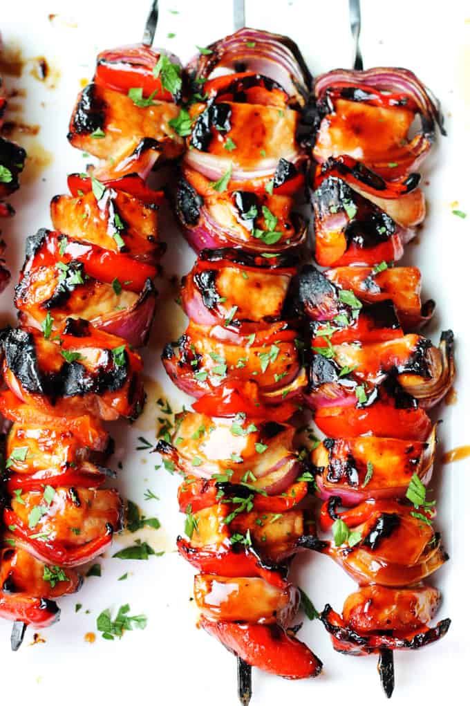 Honey BBQ Pork Souvlaki with Grilled Lemons & Tzatziki is a very easy and flavorful summer dish made on the outdoor grill that marries Greek cuisine (souvlaki, tzatziki & lemon) with American classic Honey BBQ Sauce from Budweiser. Honey BBQ Pork Souvlaki on a plate 2