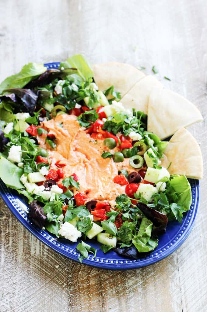 Mediterranean hummus platter on blue plate
