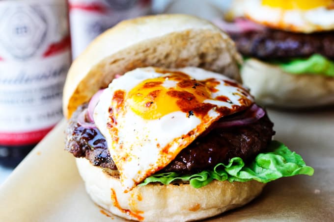 Smoky BBQ Burger with Garlic Aioli & Fried Egg is a perfect summer meal that uses Budweiser Sweet & Smoky BBQ sauce, beef patties, fried eggs, pickled onions and garlic aioli. Smoky BBQ burger with fried egg and smoked paprika
