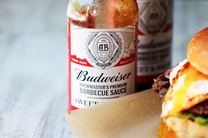 Smoky BBQ Burger with Garlic Aioli & Fried Egg is a perfect summer meal that uses Budweiser Sweet & Smoky BBQ sauce, beef patties, fried eggs, pickled onions and garlic aioli. Budweiser BBQ sauce