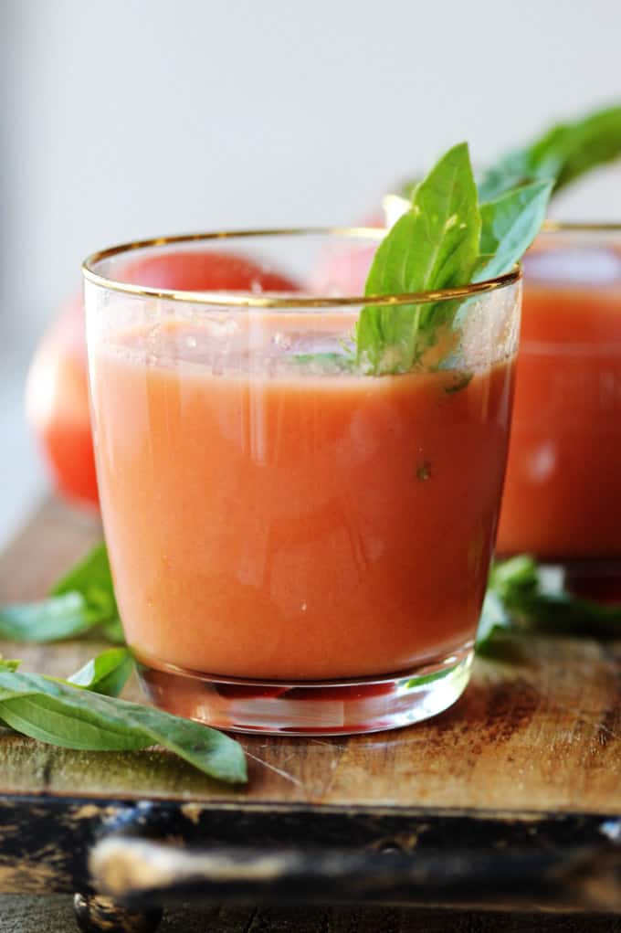 Spanish gazpacho in a glass with basil garnish