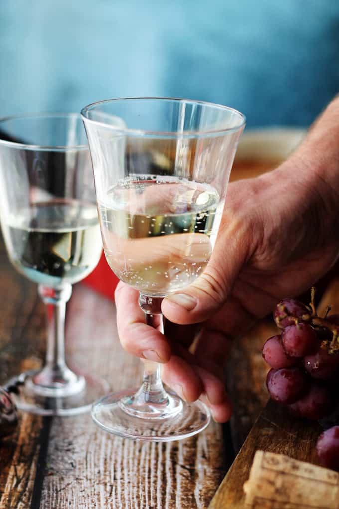 Holding the glass with Italian dessert wine Moscato D'Asti