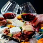 Glasses of red Italian wine and cheese with meat board
