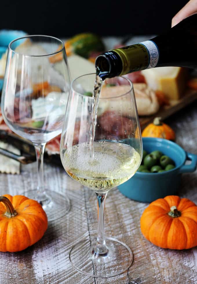 Pouring white Italian wine into a glass