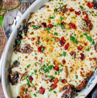 Cheesy Brussels Sprouts with bacon in an oval baking dish