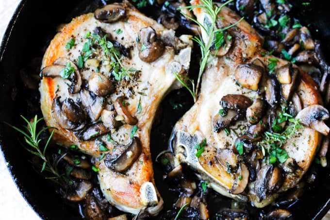 pork chops in cast iron skillet with mushrooms