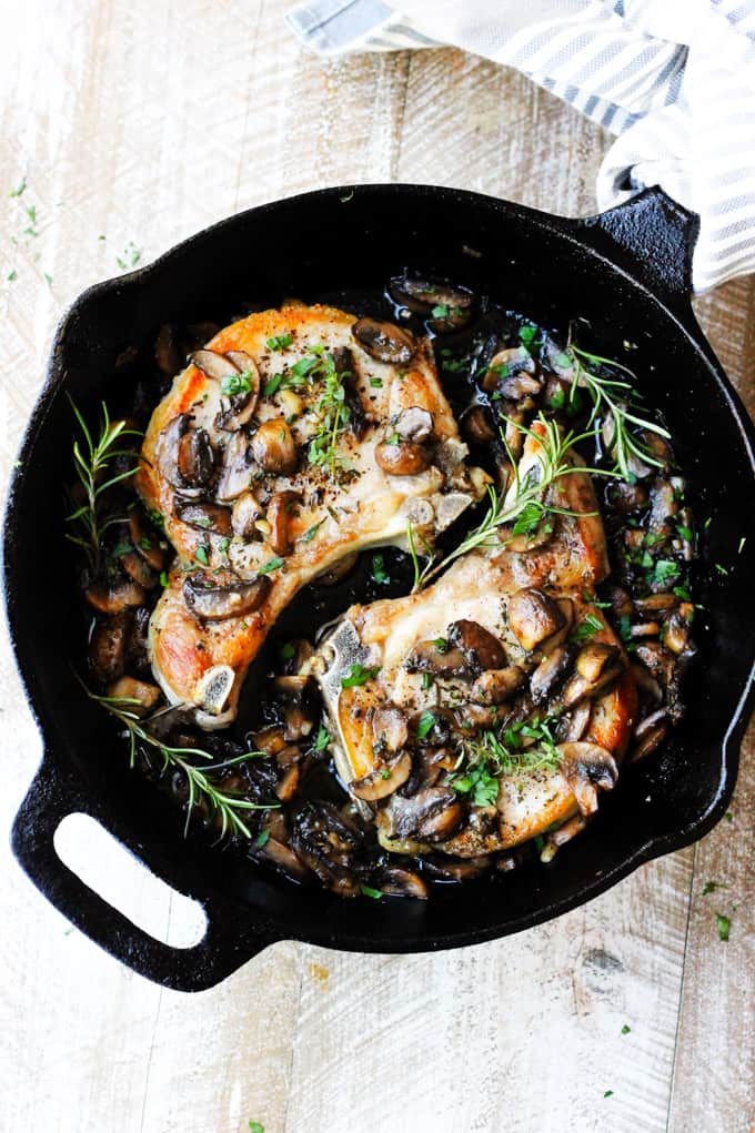 pork chops with mushrooms in cast iron skillet