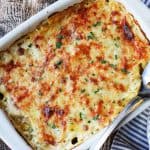 Acorn Butternut Squash Gratin in a casserole dish with spoon