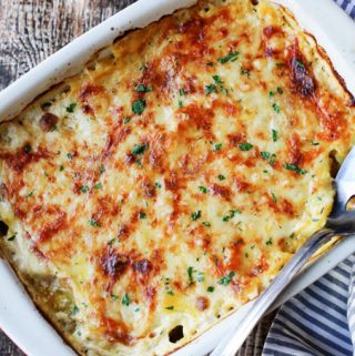Acorn Butternut Squash Gratin in a casserole dish with spoon
