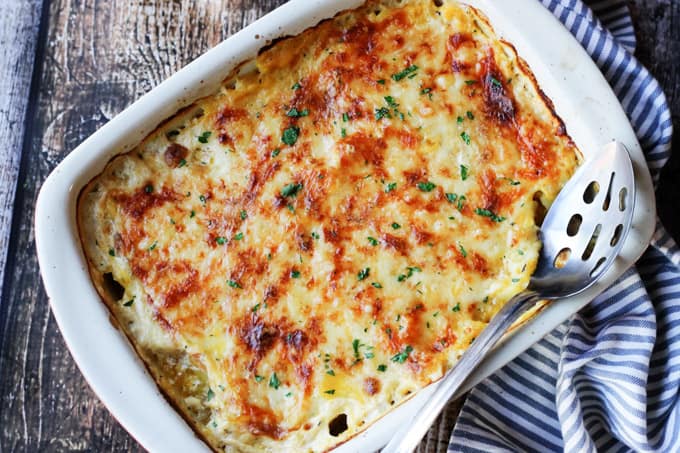 Acorn Butternut Squash Gratin in a casserole dish with spoon
