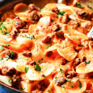 Pasta in vodka sauce in a skillet with fork