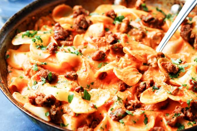 Pasta in vodka sauce in a skillet with fork