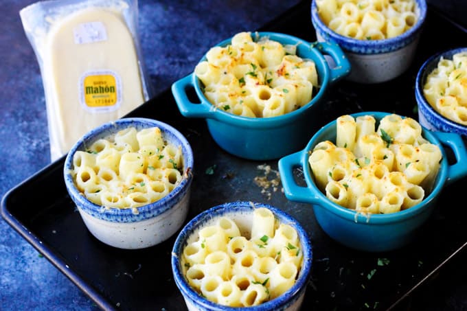 This Cheesy Pasta Bake is made Alfredo Style, with a heavy cream and two kinds of amazing Mahon-Menorca cheeses. I made these in the individual ramekins for a perfect portioned side dish. Baked pasta Alfredo style in ramekins