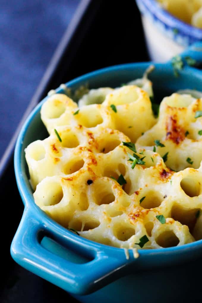 This Cheesy Pasta Bake is made Alfredo Style, with a heavy cream and two kinds of amazing Mahon-Menorca cheeses. I made these in the individual ramekins for a perfect portioned side dish. Individual ramekin with baked pasta Alfredo Style with Mahon cheese