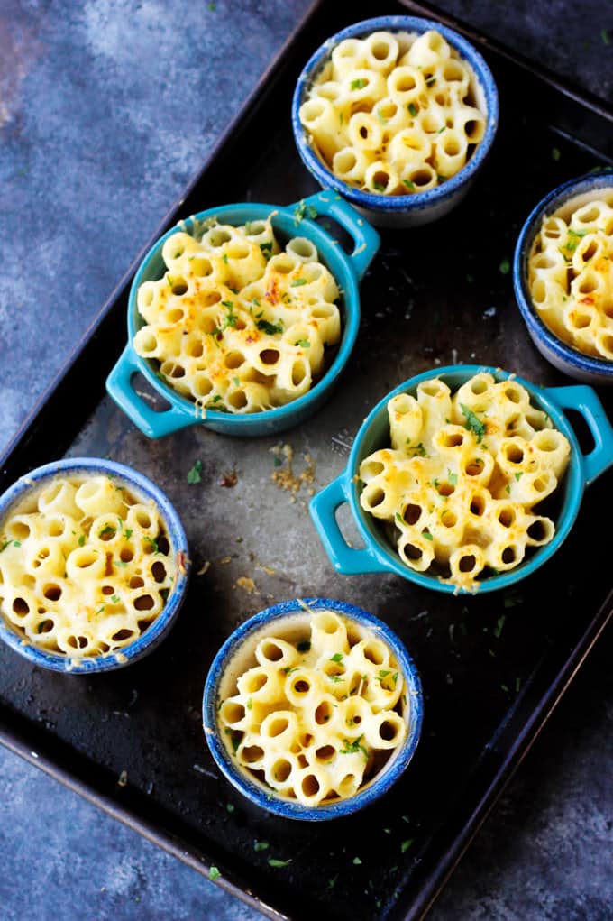 This Cheesy Pasta Bake is made Alfredo Style, with a heavy cream and two kinds of amazing Mahon-Menorca cheeses. I made these in the individual ramekins for a perfect portioned side dish. Individual pasta bake made with Mahon Menorca cheese