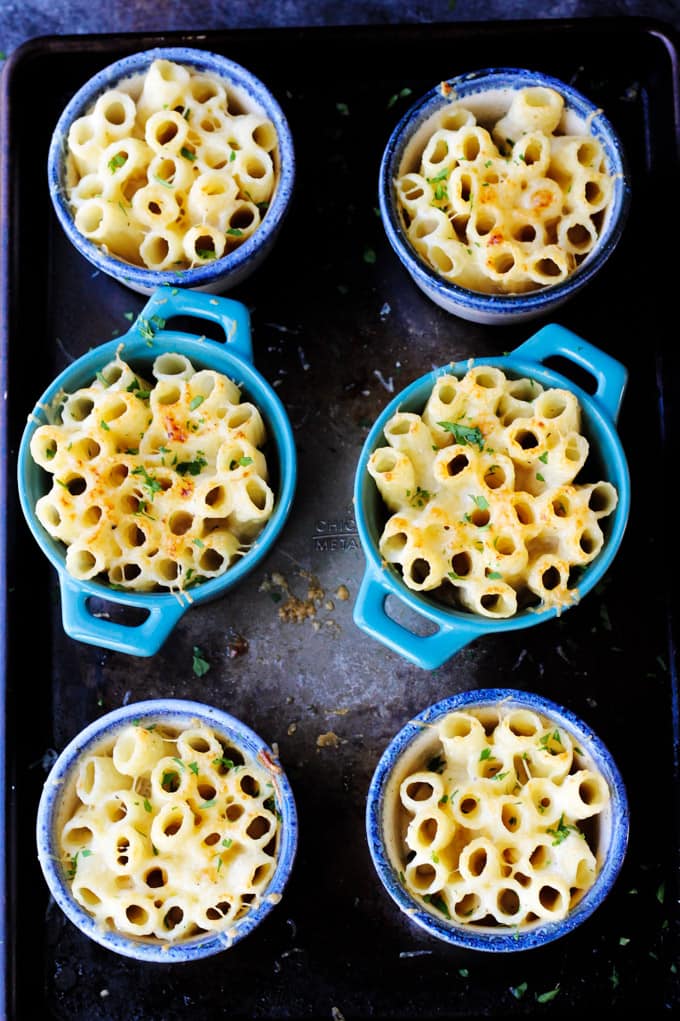 This Cheesy Pasta Bake is made Alfredo Style, with a heavy cream and two kinds of amazing Mahon-Menorca cheeses. I made these in the individual ramekins for a perfect portioned side dish. Cheesy Pasta Bake in Individual ramkins on a sheet pan