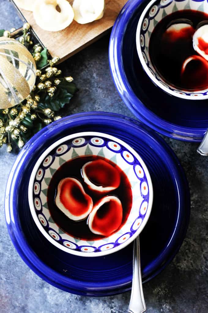 In Poland Mushroom Pierogi called "Uszka" are traditionally served in Borscht on Christmas Eve. They're made from both dry and fresh mushrooms, and a simple pierogi dough of flour, water, milk, and butter. They're beautiful and easier to make than you'd think. Mushroom Pierogi Uszka with Borscht in blue bowls