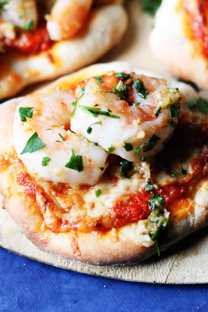 Close up of garlic shrimp on roasted pepper pesto pizzette