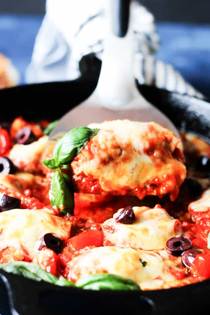 Veal rollatini in tomato sauce picked up from the skillet with spatula