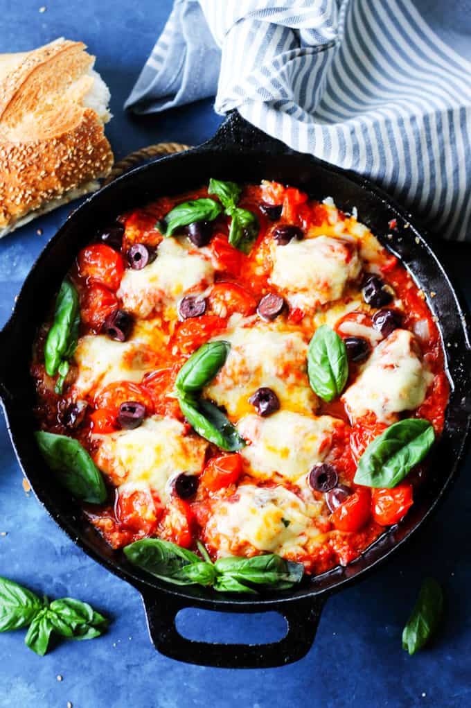 Veal Involtini with basil cheese and peppers in tomato olive sauce in a skillet