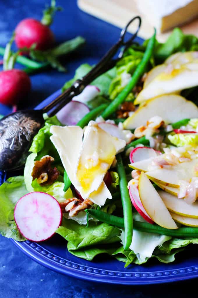 French Salad with Brie and Pears is a wonderful option for those nights when you want to eat a salad but you desire a bit more than just a simple Green Salad. This French Salad recipe is perfect when you want to eat low carb meal without sacrificing on taste and nutrition. Butter lettuce, French green beans, radishes, and pears add a healthy dose of vitamins; and walnuts - give you some healthy fats; and finally the brie cheese - will provide you with needed protein. This salad is naturally gluten-free, and oh so delicious! Close up of the french salad with brie, pears, radishes and beans